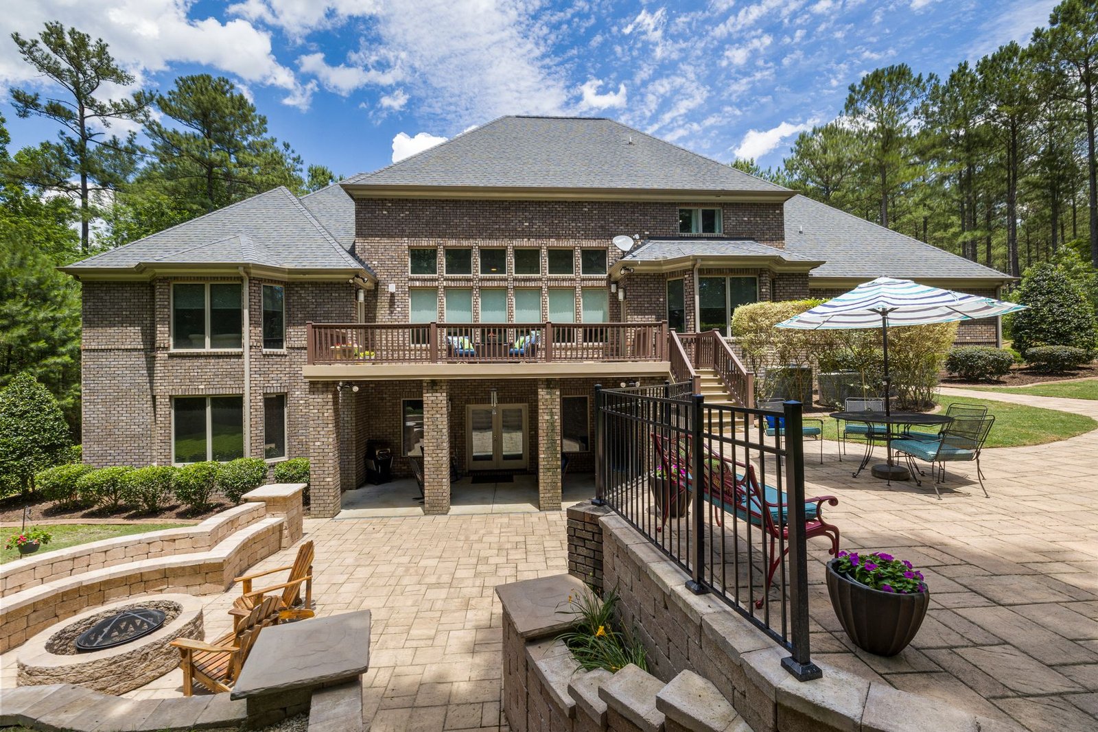 Backyard paver terrace with a fire pit and seating